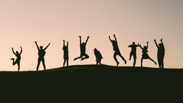 silhouette photo of group of people on mountain