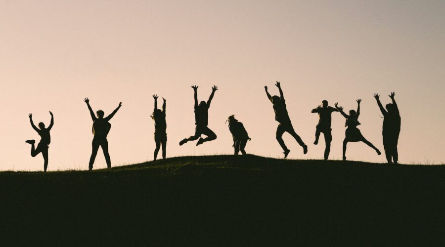 silhouette photo of group of people on mountain